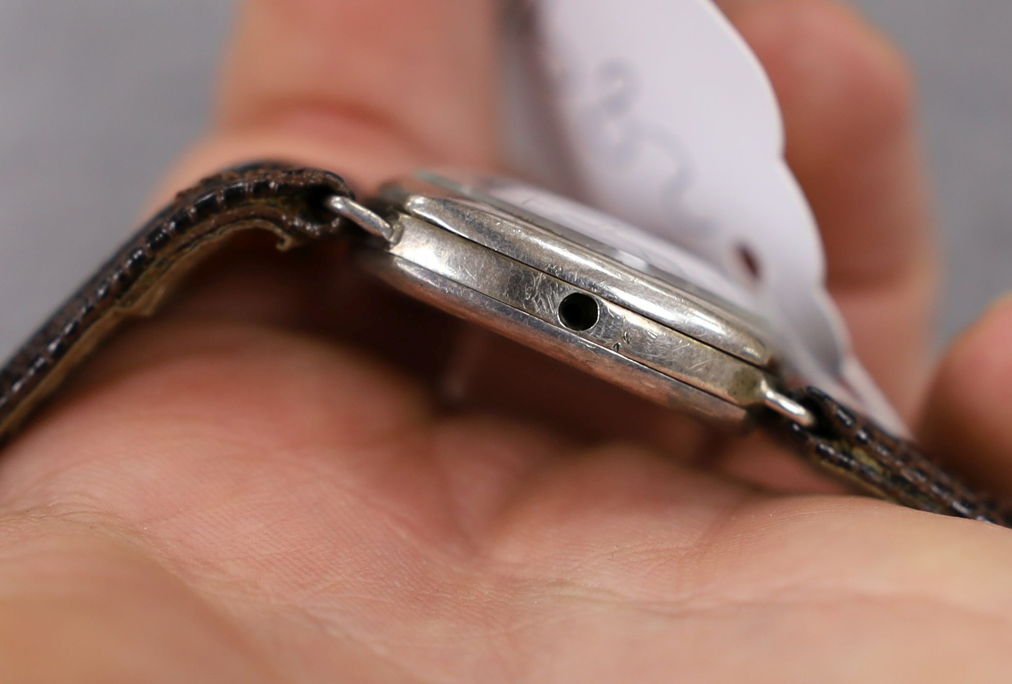 A gentleman's 1920's silver wrist watch, with Arabic dial and subsidiary seconds, the dial signed Rolex, movement unsigned, lacking winding crown.